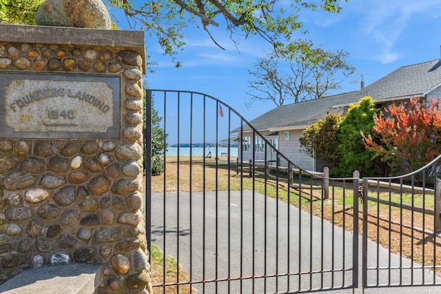 view of gate with a water view