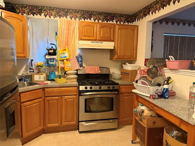 kitchen with sink, light tile patterned flooring, and appliances with stainless steel finishes