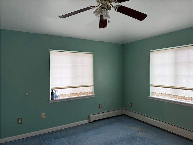 carpeted spare room featuring baseboard heating and plenty of natural light