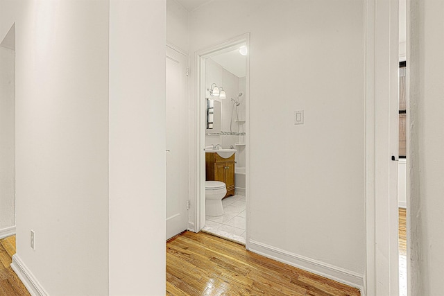 corridor with light hardwood / wood-style flooring