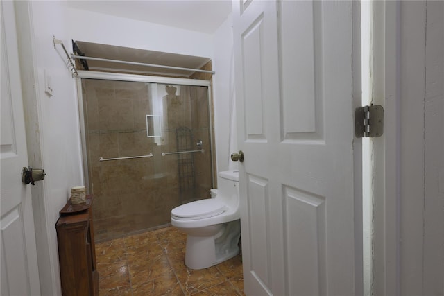 bathroom with a shower with door and toilet