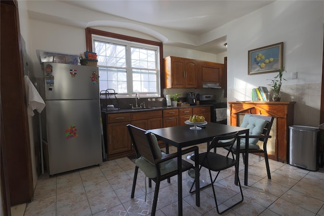 dining room with sink and light tile patterned flooring