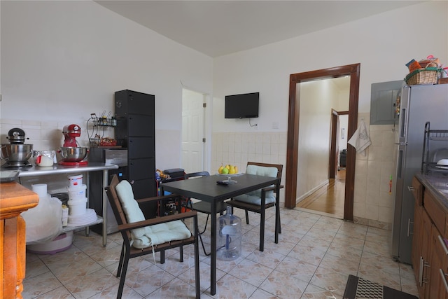 tiled dining room with tile walls