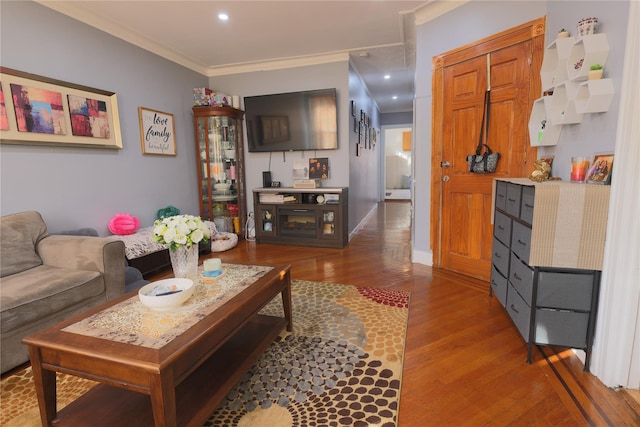 living room with crown molding and hardwood / wood-style floors