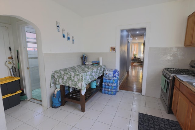 tiled dining area featuring tile walls