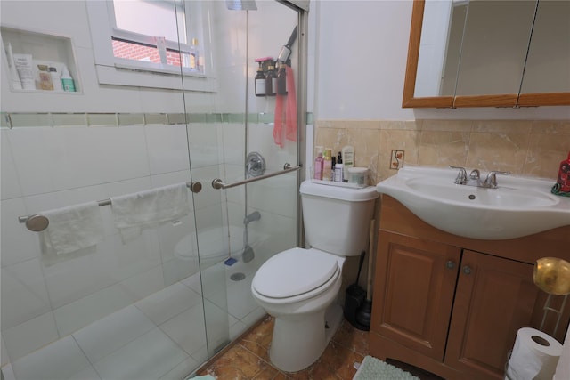 bathroom featuring vanity, toilet, and a shower with shower door