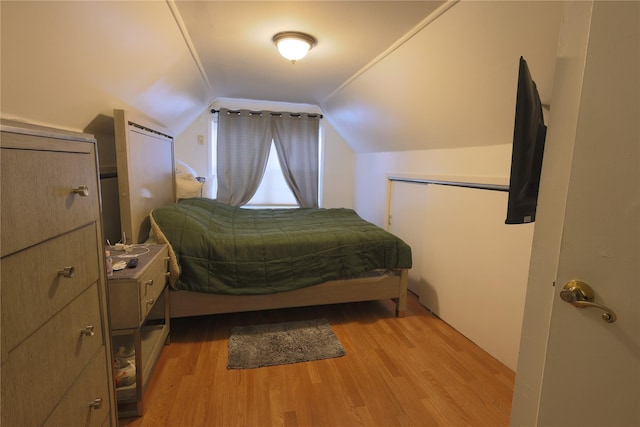 bedroom featuring vaulted ceiling and light hardwood / wood-style flooring