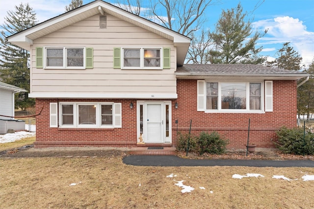 tri-level home with a front lawn