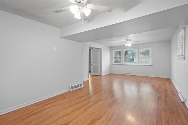 unfurnished room featuring ceiling fan, a baseboard radiator, ornamental molding, and light hardwood / wood-style flooring