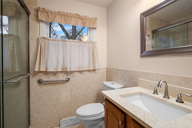 bathroom featuring vanity, tile walls, walk in shower, and toilet