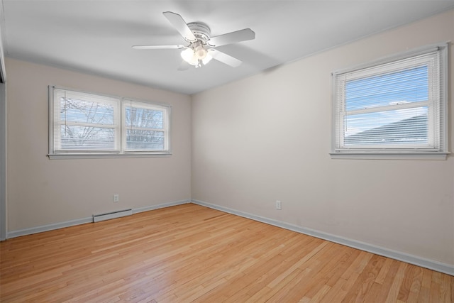 unfurnished room featuring a baseboard heating unit, light hardwood / wood-style floors, and ceiling fan