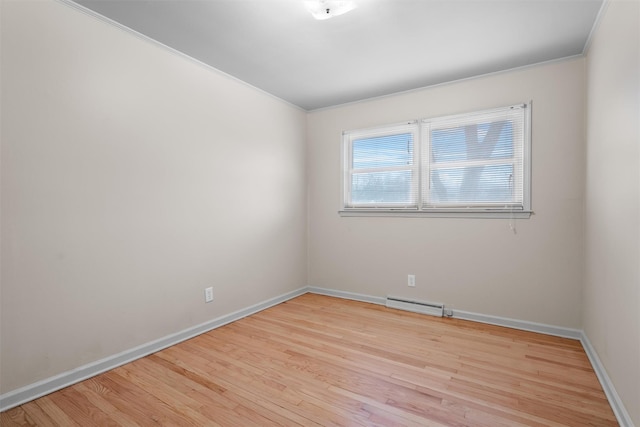 empty room featuring crown molding and light hardwood / wood-style floors