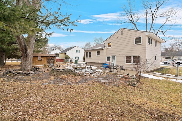 back of house with an outdoor structure and a patio area