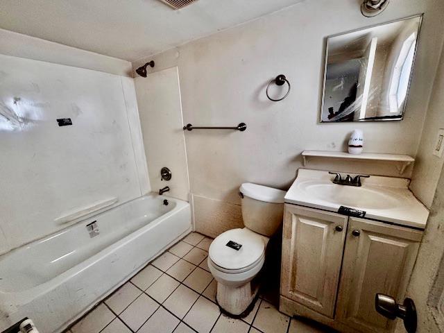 full bathroom with vanity, tub / shower combination, tile patterned floors, and toilet