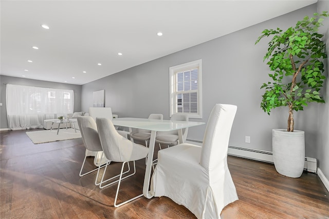 dining space featuring dark wood-type flooring and a baseboard radiator