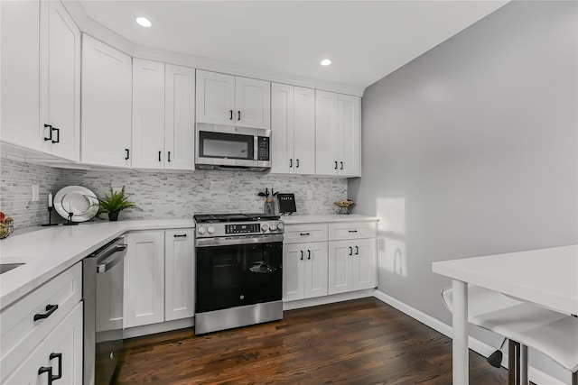 kitchen with white cabinetry, decorative backsplash, and appliances with stainless steel finishes