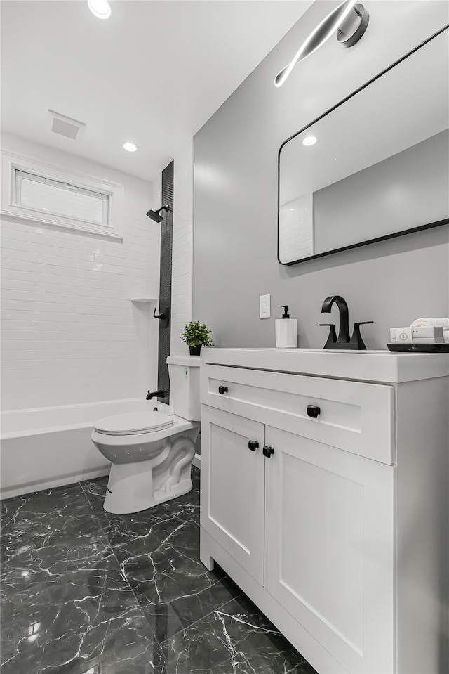 full bathroom featuring vanity, toilet, and tiled shower / bath