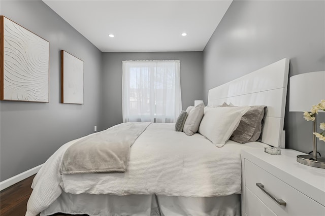 bedroom with dark hardwood / wood-style floors