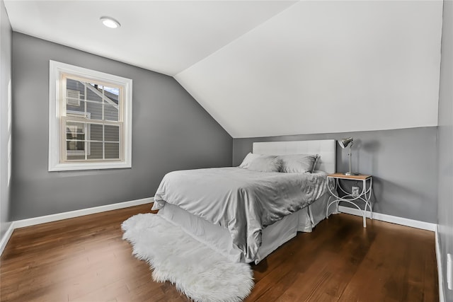 bedroom with lofted ceiling and dark hardwood / wood-style floors