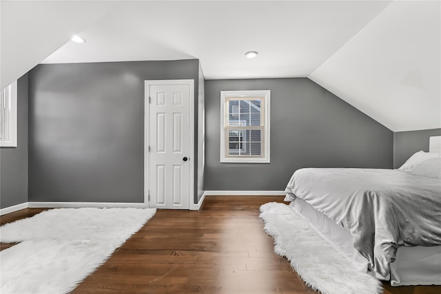 bedroom featuring dark hardwood / wood-style flooring and vaulted ceiling