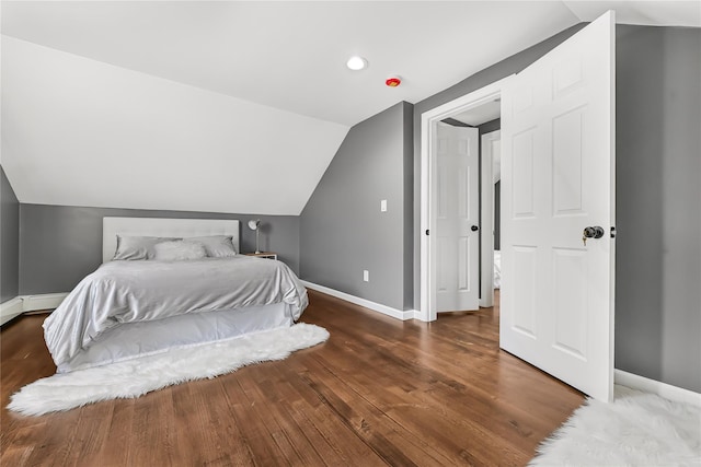 bedroom with lofted ceiling and dark hardwood / wood-style flooring