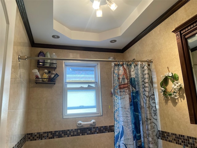 bathroom with a shower with curtain, ornamental molding, and a raised ceiling