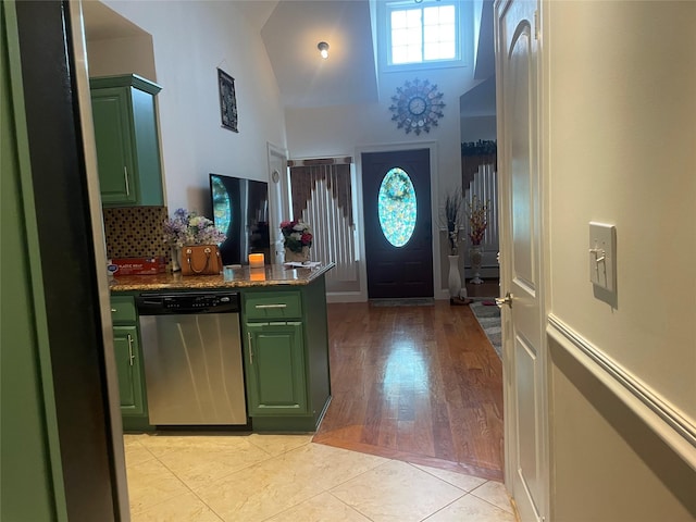 tiled entryway with lofted ceiling