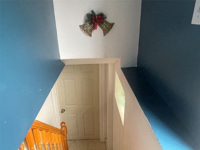 staircase featuring tile patterned floors