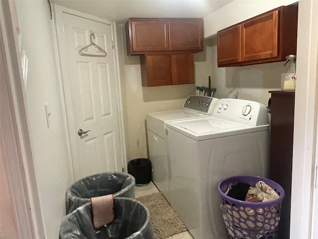 laundry area featuring washing machine and dryer and cabinets