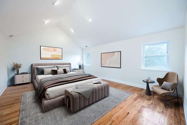 bedroom featuring vaulted ceiling and light hardwood / wood-style floors