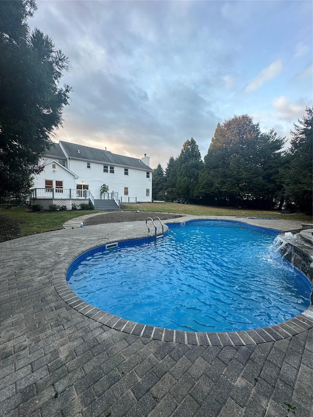 view of pool with a patio area and pool water feature