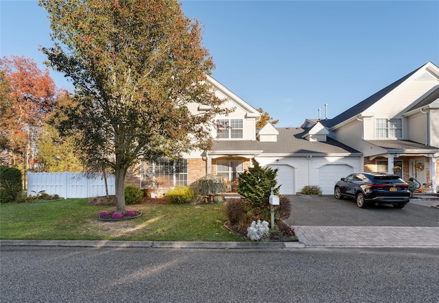 view of front of home with a garage and a front yard