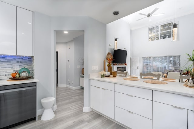 kitchen featuring white cabinetry, decorative backsplash, and pendant lighting