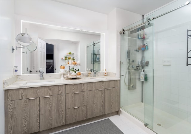 bathroom featuring walk in shower, vanity, and tile patterned flooring