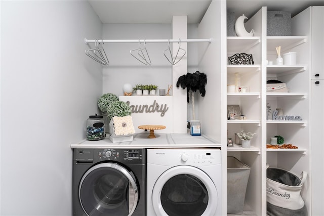 clothes washing area featuring separate washer and dryer