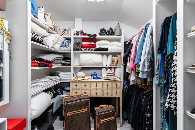 walk in closet featuring vaulted ceiling