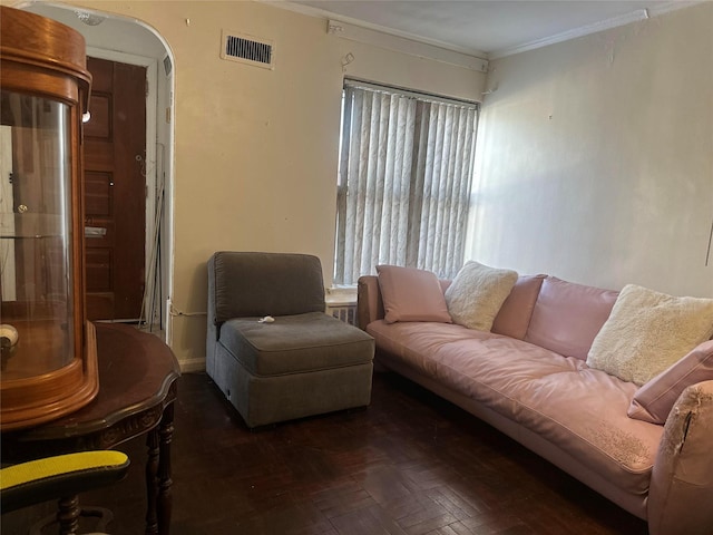 living room with ornamental molding and dark parquet floors