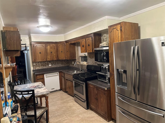 kitchen featuring sink, decorative backsplash, ornamental molding, and appliances with stainless steel finishes