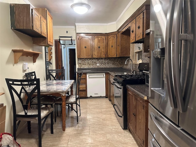 kitchen featuring sink, decorative backsplash, ornamental molding, and appliances with stainless steel finishes