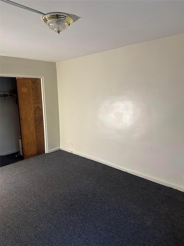 unfurnished bedroom featuring carpet floors and a closet