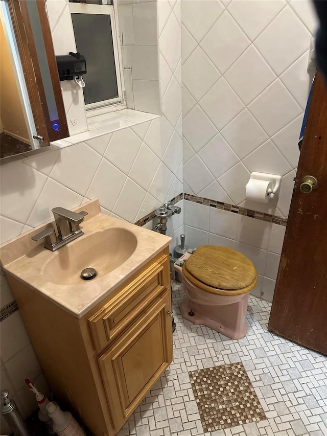 bathroom featuring vanity, tile walls, and backsplash