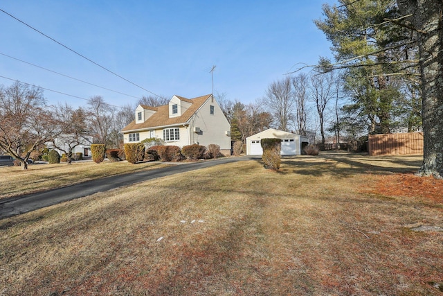 view of home's exterior featuring an outbuilding, a lawn, fence, and a garage