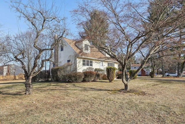 view of side of home featuring a lawn