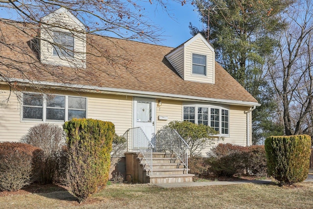 cape cod-style house featuring a shingled roof