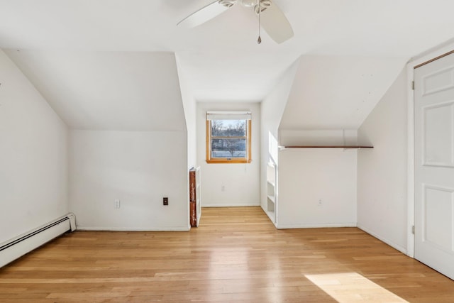 bonus room with light wood finished floors, a baseboard radiator, vaulted ceiling, and ceiling fan