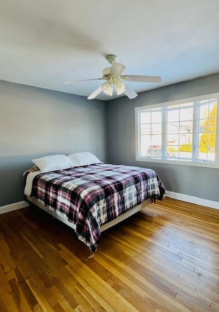 bedroom with hardwood / wood-style flooring and ceiling fan