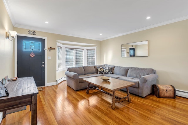 living room featuring baseboard heating, ornamental molding, and light hardwood / wood-style floors