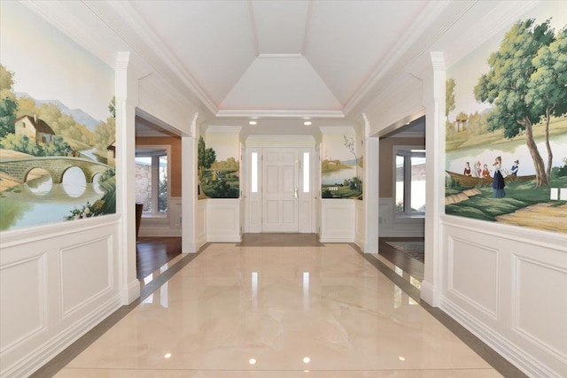 foyer with crown molding and lofted ceiling