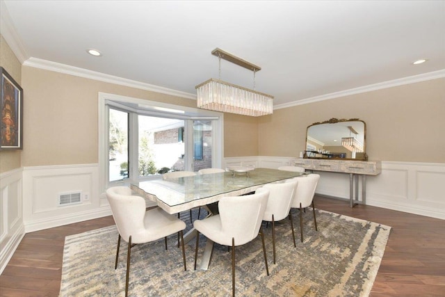 dining room featuring crown molding and dark hardwood / wood-style floors