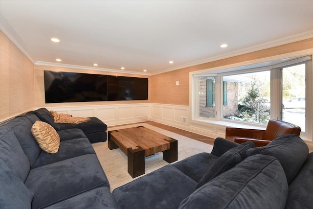 living room with hardwood / wood-style flooring and ornamental molding